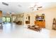 Open living room area with tile flooring, ceiling fans, neutral paint and plenty of open space at 9313 Lisbon St, Seffner, FL 33584