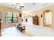Living room featuring tile floors, ceiling fan, a large window and neutral colored walls at 9313 Lisbon St, Seffner, FL 33584