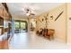 Open-concept living area features tile flooring, patio access, dining area and unique wall decorations at 9313 Lisbon St, Seffner, FL 33584