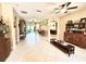 Open living room boasts tile flooring, a ceiling fan, and an open floor plan with multiple archways at 9313 Lisbon St, Seffner, FL 33584