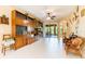 Large living room featuring custom wooden shelves, tile floors and a ceiling fan at 9313 Lisbon St, Seffner, FL 33584