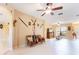 Spacious living room with tile flooring, ceiling fan, and decorative wall accents at 9313 Lisbon St, Seffner, FL 33584