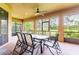 Spacious screened-in patio with an outdoor dining area and serene backyard views at 9313 Lisbon St, Seffner, FL 33584