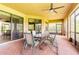 Inviting screened-in patio with an outdoor dining area and lush green scenery at 9313 Lisbon St, Seffner, FL 33584