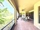 Covered patio with brick flooring, ceiling fan, and outdoor seating area overlooking the green backyard at 9313 Lisbon St, Seffner, FL 33584
