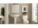 This powder room offers a classic toilet, space-saving sink and a large window to bring in natural light at 9376 Gladsome Dr, Land O Lakes, FL 34637