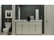 Modern bathroom featuring double sinks, a dark vanity, granite countertop, and framed artwork at 9376 Gladsome Dr, Land O Lakes, FL 34637