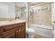 Bathroom featuring a single sink vanity and shower over tub with glass doors at 984 Chickadee Dr, Venice, FL 34285