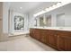 Spacious bathroom with a large vanity, soaking tub, and neutral tile at 984 Chickadee Dr, Venice, FL 34285