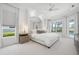 Bright main bedroom featuring tray ceilings, plush carpet, and backyard views at 984 Chickadee Dr, Venice, FL 34285