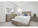 Bright bedroom features large window, dresser, and bench at 984 Chickadee Dr, Venice, FL 34285