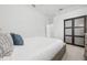 Bright bedroom with closet featuring sliding black doors at 984 Chickadee Dr, Venice, FL 34285