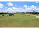 Scenic view of a lush green golf course with mature trees and a tranquil lake at 984 Chickadee Dr, Venice, FL 34285
