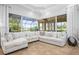 Living room highlighting plush seating and a screened-in patio area with stunning views at 984 Chickadee Dr, Venice, FL 34285