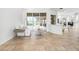 Bright and airy living room with neutral tones, tile flooring, and seamless access to the outdoor pool area at 984 Chickadee Dr, Venice, FL 34285