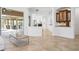 Bright and airy living room with neutral tones, tile flooring, and seamless access to the outdoor pool area at 984 Chickadee Dr, Venice, FL 34285