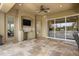 Covered patio featuring a wet bar, ceiling fan, and tile flooring at 984 Chickadee Dr, Venice, FL 34285