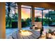 Outdoor patio featuring a fire pit and comfortable seating, ideal for enjoying serene views at 984 Chickadee Dr, Venice, FL 34285