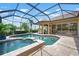Beautiful screened in pool and lanai area with golf course in the background at 984 Chickadee Dr, Venice, FL 34285