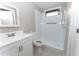 This bathroom features a white vanity and shower with a neutral color scheme at 9834 Miramar St, New Port Richey, FL 34654