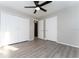 Spacious bedroom featuring laminate flooring, a ceiling fan, closet, and neutral wall color, creating a relaxing atmosphere at 9834 Miramar St, New Port Richey, FL 34654