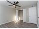 Serene bedroom with a modern ceiling fan, spacious closet, and durable laminate flooring, creating a comfortable retreat at 9834 Miramar St, New Port Richey, FL 34654