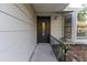 Inviting front entrance featuring a stylish door with glass insert, enhanced by decorative plants and fresh landscaping at 9834 Miramar St, New Port Richey, FL 34654