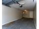 This unfinished garage features a water heater and door to access the house at 9834 Miramar St, New Port Richey, FL 34654