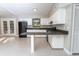 Bright kitchen equipped with white cabinetry, black appliances, and ample counter space for meal preparation at 9834 Miramar St, New Port Richey, FL 34654