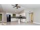 The kitchen features white cabinets, tile floors, and an open layout with modern appliances at 9834 Miramar St, New Port Richey, FL 34654
