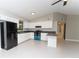 This kitchen features white cabinets, tile floors, and an open layout at 9834 Miramar St, New Port Richey, FL 34654