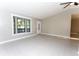 This living room features tile floors and a picture window, with neutral color walls at 9834 Miramar St, New Port Richey, FL 34654