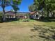 Lush backyard with a screened lanai, mature trees, and well-maintained lawn at 9127 Woodridge Run Dr, Tampa, FL 33647