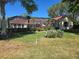 Lush backyard with a screened lanai, mature trees, and well-maintained lawn at 9127 Woodridge Run Dr, Tampa, FL 33647