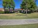Well-manicured backyard with a screened lanai and mature trees at 9127 Woodridge Run Dr, Tampa, FL 33647