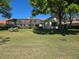 Spacious backyard featuring a screened lanai, lush lawn, and mature trees at 9127 Woodridge Run Dr, Tampa, FL 33647