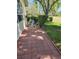 Paver patio with view of lawn and golf course beyond hedge at 9127 Woodridge Run Dr, Tampa, FL 33647