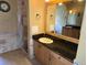 Primary bathroom featuring stone tile, large vanity with granite countertop and walk-in shower at 9127 Woodridge Run Dr, Tampa, FL 33647