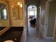 Open concept bathroom features double vanity, tiled floors and view into the living room at 9127 Woodridge Run Dr, Tampa, FL 33647