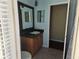 Bathroom featuring a vanity with granite counters and a mirror at 9127 Woodridge Run Dr, Tampa, FL 33647