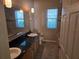 Bathroom with a double vanity, granite countertop and warm lighting at 9127 Woodridge Run Dr, Tampa, FL 33647