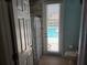 Bathroom showcasing a door to the pool area, tile flooring, and updated fixtures at 9127 Woodridge Run Dr, Tampa, FL 33647