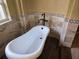 Close up of free standing bathtub with elegant faucet, unique tile and wood floor at 9127 Woodridge Run Dr, Tampa, FL 33647