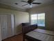 Bedroom with a ceiling fan, closet and window with views of the pool at 9127 Woodridge Run Dr, Tampa, FL 33647