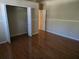 Bedroom with a closet, wood floors and neutral paint at 9127 Woodridge Run Dr, Tampa, FL 33647