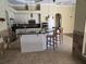 Modern kitchen with stainless steel appliances, granite countertops, and a large breakfast bar with seating at 9127 Woodridge Run Dr, Tampa, FL 33647