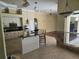 Bright kitchen featuring a breakfast bar, modern appliances, and seamless access to other living spaces at 9127 Woodridge Run Dr, Tampa, FL 33647