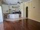 Kitchen featuring white cabinets, stainless appliances, island, and hardwood flooring at 9127 Woodridge Run Dr, Tampa, FL 33647