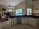 Open kitchen with dark countertops, white cabinets, stainless steel appliances, and a view of the pool at 9127 Woodridge Run Dr, Tampa, FL 33647