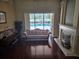 Elegant living room with hardwood floors, fireplace, and view of pool at 9127 Woodridge Run Dr, Tampa, FL 33647
